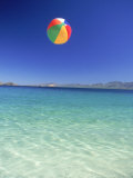 Beach Ball in Air Over Water at Beach Photographic Print by David Porter