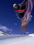 Snowboarder with Colorful Board Doing a Trick Photographic Print by Kurt Olesek