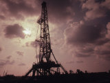 Silhouette of an Oil Rig at Sunset Photographic Print by William Swartz
