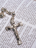 Silver Crucifix Lying on Open Bible Photographic Print by David Davis