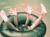 Legs and Feet of a Child in Pool's Tube Photographie par Maria Taglienti