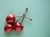 Three Cherries on a Green Background Photographic Print by Karen M. Romanko