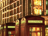 Telephone Booths in Front Store, London, England Photographic Print by Walter Bibikow