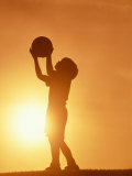 Silhouette of Boy Holding Basketball Photographic Print