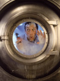 Man with Tool in Washing Machine Fotografisk trykk av John Burke