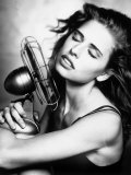 Portrait of a Woman Cooling Herself with a Fan Photographie