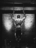 Rear View of Muscular Man Holding Chains Fotografie-Druck von Dennis Lane