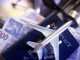 Model Jet Over US Passport and Foreign Currencies Photographic Print by Eric Kamp