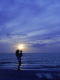 Silhouette of Mother and Child on Beach at Sunset Photographic Print by Greg Smith
