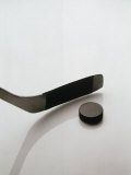 Hockey Stick and Puck Fotografisk tryk af Howard Sokol