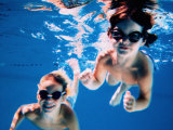Boy and Girl Wearing Goggles Underwater Photographic Print by Chris Briscoe