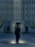 Man with Umbrella Under a Regional Rain Photographic Print by Joseph Hancock