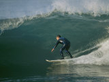 A Surfer Rides a Wave Photographic Print by Roy Toft