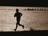 Silhouette of a Jogger Next to Water Photographie par Roy Gumpel