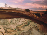 Mountain-Biking over a Natural Arch Photographic Print by Kate Thompson