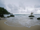 A man stands with a surfboard on a beach in the Dominican Republic Lámina fotográfica por Stephen Alvarez A man stands with a surfboard on a beach in the Dominican Republic Lámina fotográfica por Stephen Alvarez