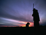 A Silhouetted Hunter and His Dog at Twilight Photographic Print by Gordon Wiltsie