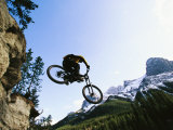 Man Jumping on His Mountain Bike with Ha Ling Peak in the Background Photographic Print by Mark Cosslett