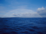 A Rainbow Rises over the Waters Surface in Twofold Bay Photographic Print by Jason Edwards
