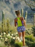 A Woman Runs Through the Desert Landscape Photographic Print by Dugald Bremner