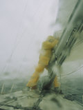 A Sailor Reefs the Boats Mainsail During a Blustery Squall Photographic Print by Skip Brown