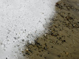 Thin Layer of Snow Covering Pebbles and Sand on a Beach Photographic Print by Todd Gipstein