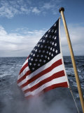 An American Flag Flutters from the Back of a Boat in Neah Bay Photographic Print by Sam Abell