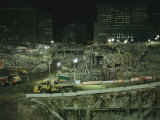 An Elevated View of Ground Zeros Devastation at Night; Crews, Their Vehicles, and Other Equipment Photographie par Ira Block