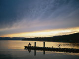 A Fisherman at Dawn Tries His Luck from the End of a Pier Photographic Print by Michael S. Lewis