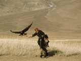 A Kazakh Falconer Hunts with His Golden Eagle Photographic Print by David Edwards
