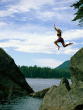 A Climber Freefalls from a Cliff into the Claquot Sound in British Columbia Photographic Print by Barry Tessman