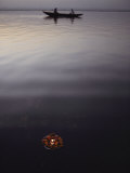 A Flower Offering Floats Past a Boat on the Ganges Photographic Print by George F. Mobley