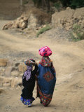 A Yemeni Woman and Child Carrying Bundles on Their Heads Photographic Print by Michael Melford