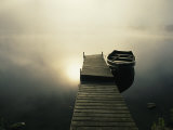 The Morning Sun Shines on a Rowboat Tied to a Dock Photographic Print by Stephen Alvarez