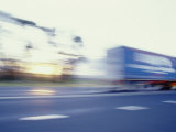 A Tractor Trailer Speeding Down a Highway at Sunset Photographic Print by Jason Edwards