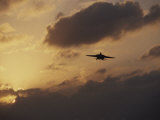 A Jet Comes in for a Landing on an Aircraft Carrier at Twilight Photographic Print