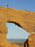 Brad Richman Rides his Bicycle over Hole in the Rock Formation Lámina fotográfica por Bill Hatcher