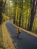 A Cyclist Riding Along a Rural Road in the Fall Photographie par Skip Brown