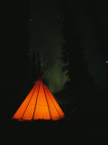 The Glow from a Campfire Makes a Shadow on a Tepee Photographic Print by Raymond Gehman