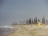 Beach Scene with Oil Rigs in the Background Photographic Print by Joseph Baylor Roberts