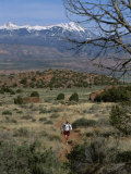 A Runner on the Hidden Valley Trail Above Moab, Utah Photographic Print by Bill Hatcher