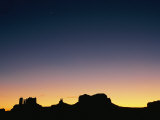 Sunset Silhouetting the Desert Landscape Photographic Print by Rich Reid