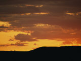 Low Sunlight Colors the Sky and Clouds in Shades of Orange Photographic Print by Raymond Gehman