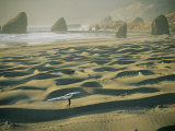 A Windsurfer Walks Across the Sand Dunes Near the Rocky Coastline Photographic Print by Skip Brown