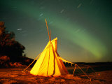Illuminated Teepee under the Northern Lights Photographic Print by Raymond Gehman