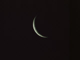 Sliver of the Moon during the New Moon Phase in Dark Black Sky Photographic Print by Tim Laman