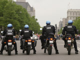 Police Officers Stand Sentinel Before a Crowd Photographie par Jim Webb
