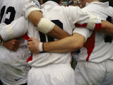 Rugby Players Huddle in a Scrum at the Annual Rugby Sevens Lámina fotográfica por Eightfish