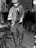 Man Playing Quoits, Like Horse Shoes, in an English Pub Photographic Print by Hans Wild