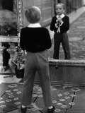 English Boy Using Reflection in Mirror in Foyer of Grand Hotel to Fix His Tie Photographic Print by Alfred Eisenstaedt